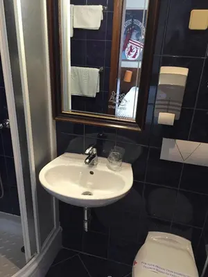 a bathroom with a sink and a toilet at Hotel Stari grad in Jajce