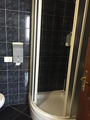 a bathroom with a shower and a toilet at Hotel Stari grad in Jajce