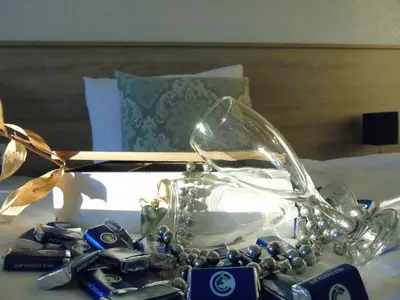 a glass purse with beads on a bed at Motel Kamenica in Bihać