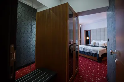 a hotel room with a bed and a sliding glass door at Hotel Exclusive President in Morančani