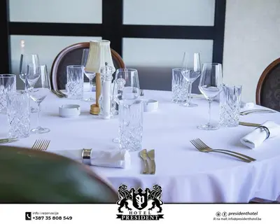 a white table with glasses and napkins on it at Hotel Exclusive President in Morančani