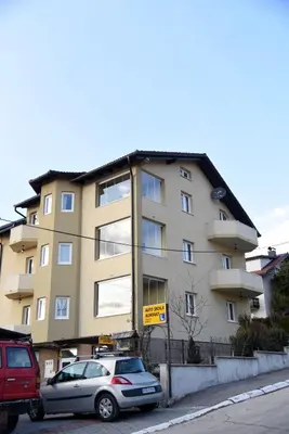 a building with a car parked in front of it at Apartment Mario in Livno