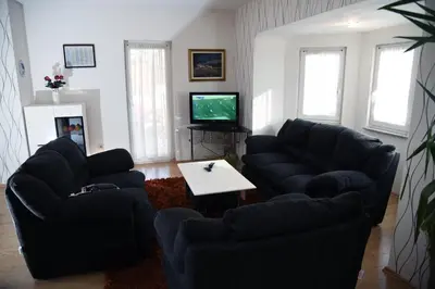 a living room with two couches and a tv at Apartment Mario in Livno