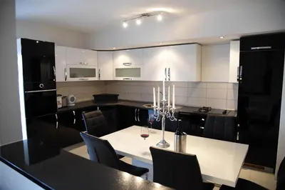a kitchen with a table with chairs and a dining room at Apartment Mario in Livno