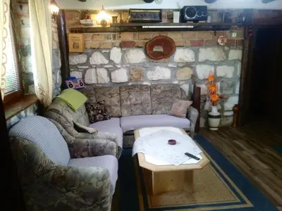 a living room with two couches and a table at Ribarska Vila in Donje Lohovo