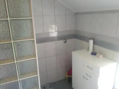 a small kitchen with a white refrigerator in a room at Ribarska Vila in Donje Lohovo