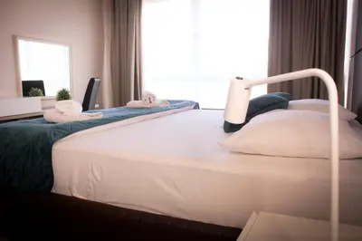 a bedroom with a bed with two pillows on it at Hotel Brcko Gas Prijedor in Prijedor