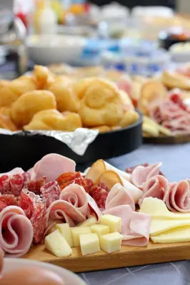 a bunch of different types of food on a table at Hotel Brcko Gas Prijedor in Prijedor