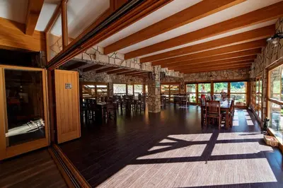 an empty dining room with tables and chairs at Zlatna Nit Pansion in Bosanska Krupa