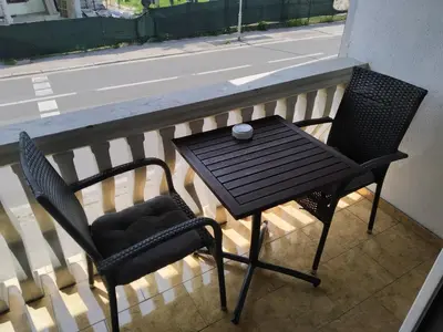 a table and two chairs sitting on a balcony at Apartment Edin in Bihać