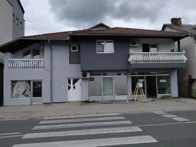a white house with a crosswalk in front of it at Apartment Edin in Bihać