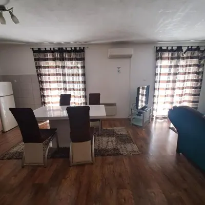 a living room with a table and chairs at Apartment Beha in Bihać
