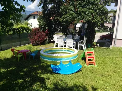 a fountain in a yard with chairs and a table at Apartment Beha in Bihać