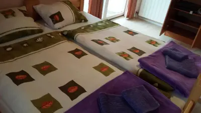 a bedroom with two beds with purple sheets at Apartmani Kastel in Banja Luka