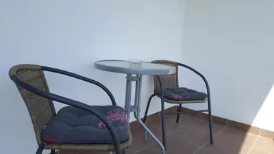 two chairs and a table and a table and chairs at Apartmani Kastel in Banja Luka