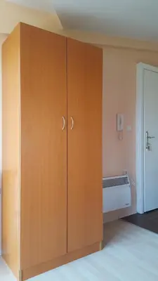 a large wooden cabinet in a room at Apartmani Kastel in Banja Luka