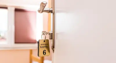 a door latch with a sign on it at Apartmani Kastel in Banja Luka