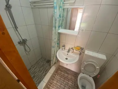 a small bathroom with a toilet and a sink at Lav Apartments in Bihać