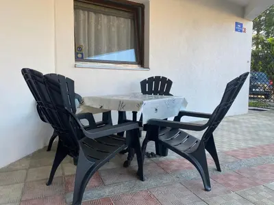 a table and chairs sitting next to a building at Lav Apartments in Bihać