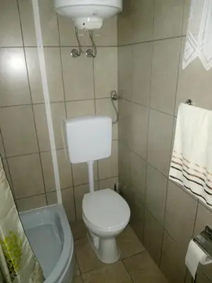 a small bathroom with a toilet and a sink at Pansion Laktaši in Laktaši