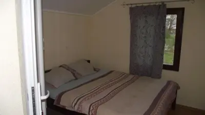 a small bedroom with a bed and a window at Pansion Laktaši in Laktaši