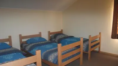 a bedroom with three bunk beds with blue pillows at Pansion Laktaši in Laktaši