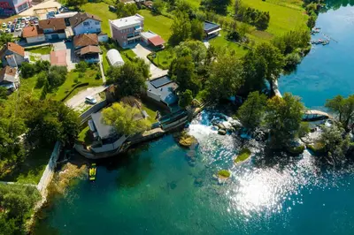 an aerial view of a river with a house at Holiday Homes Pozitiva in Bihać