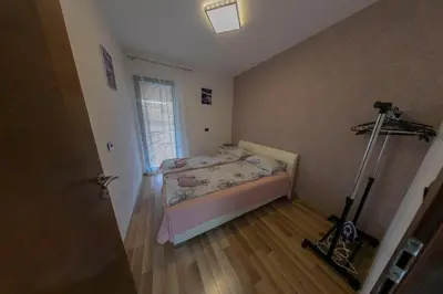 a small bedroom with a bed and a lamp at Holiday Homes Pozitiva in Bihać