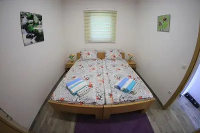 a small bedroom with a bed in a room at Holiday Homes Pozitiva in Bihać