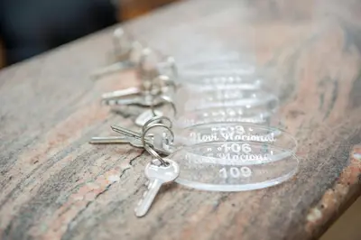 a group of silver keys on a wooden table at Prenoćište 