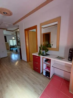 a living room with a counter and a mirror at Apartman Denis Una in Lužine