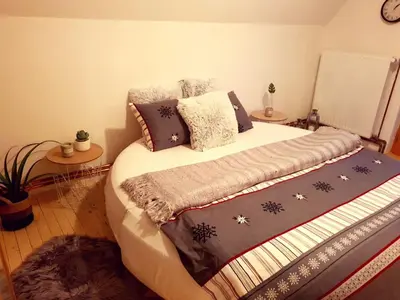 a bedroom with a large bed with pillows at Vikend Kuća Iman in Vlasic