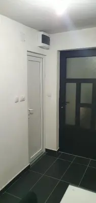 an empty room with a door and a tiled floor at Apartment Savanovic in Banja Luka