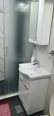 a bathroom with a sink and a mirror and a shower at Apartment Savanovic in Banja Luka