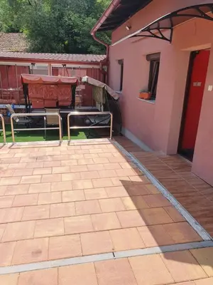 a patio with a table and chairs and a building at Apartment Savanovic in Banja Luka