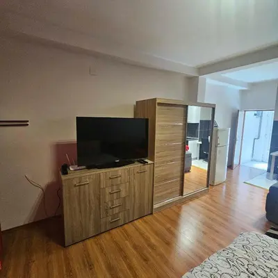 a living room with a flat screen tv on a wooden cabinet at Apartment Savanovic in Banja Luka