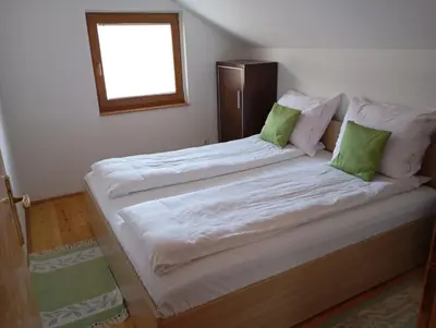 a bedroom with two beds with green pillows at Holiday Home Pharaoh in Visoko