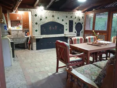 a dining room with a table and a fireplace at Holiday Home Pharaoh in Visoko