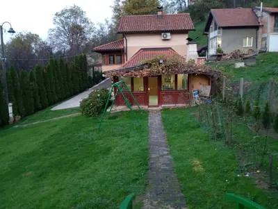 a house with a green yard in front of it at Holiday Home Pharaoh in Visoko