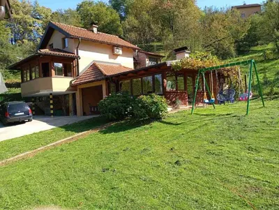 a house with a yard with a swing at Holiday Home Pharaoh in Visoko