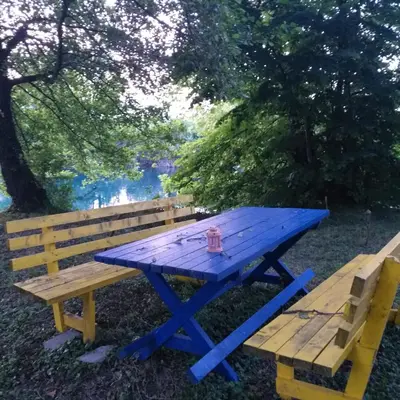 a blue picnic table next to a wooden bench at Farah Superior Apartments in Bihać