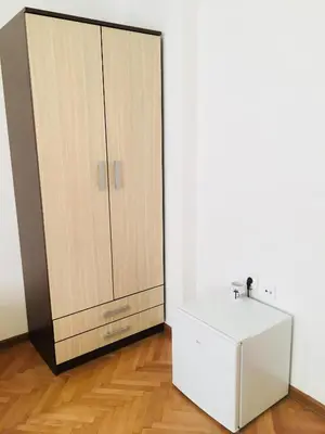 a bathroom with a white cabinet and a white refrigerator at Apartments Konak in Visoko