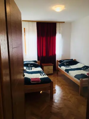 a small room with two beds and a window at Apartments Konak in Visoko