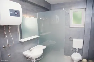 a bathroom with a white toilet and a sink at Apartments Konak in Visoko