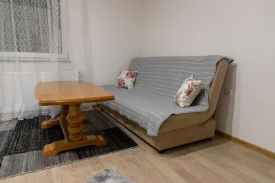 a small bedroom with a bed and a table at Apartments Aqua Resa in Bihać