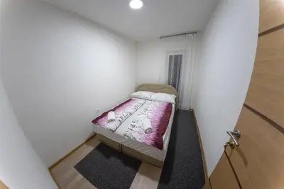 a small bedroom with a small bed in a room at Apartments Aqua Resa in Bihać