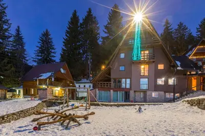 a house with a light on top of it in the snow at Vlasic Nanna & Lalla in Vlasic