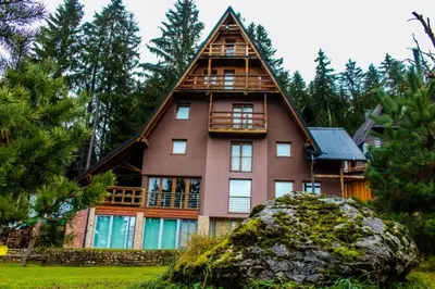 a large house with a thatched roof at Vlasic Nanna & Lalla in Vlasic