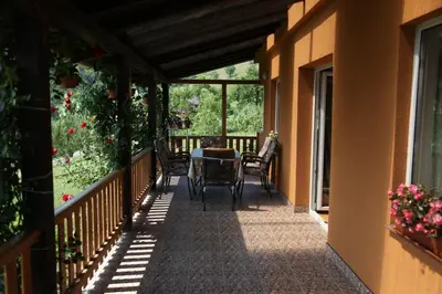 a balcony of a house with a table and chairs at Villa Meli in Visoko