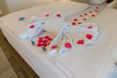 a bed with white towels and red hearts on it at Hotel Rekic in Bihać